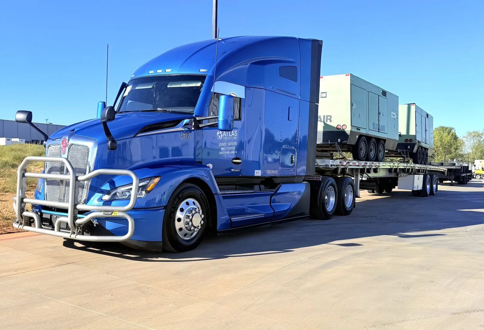 Blue Atlas Freight Line Kenworth hauling industrial compressors on a flatbed